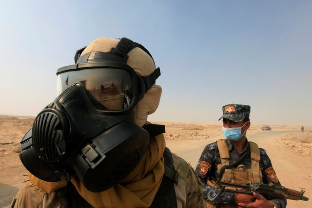 Iraqi forces after a plant was set on fire by retreating Isis fighters near Mosul