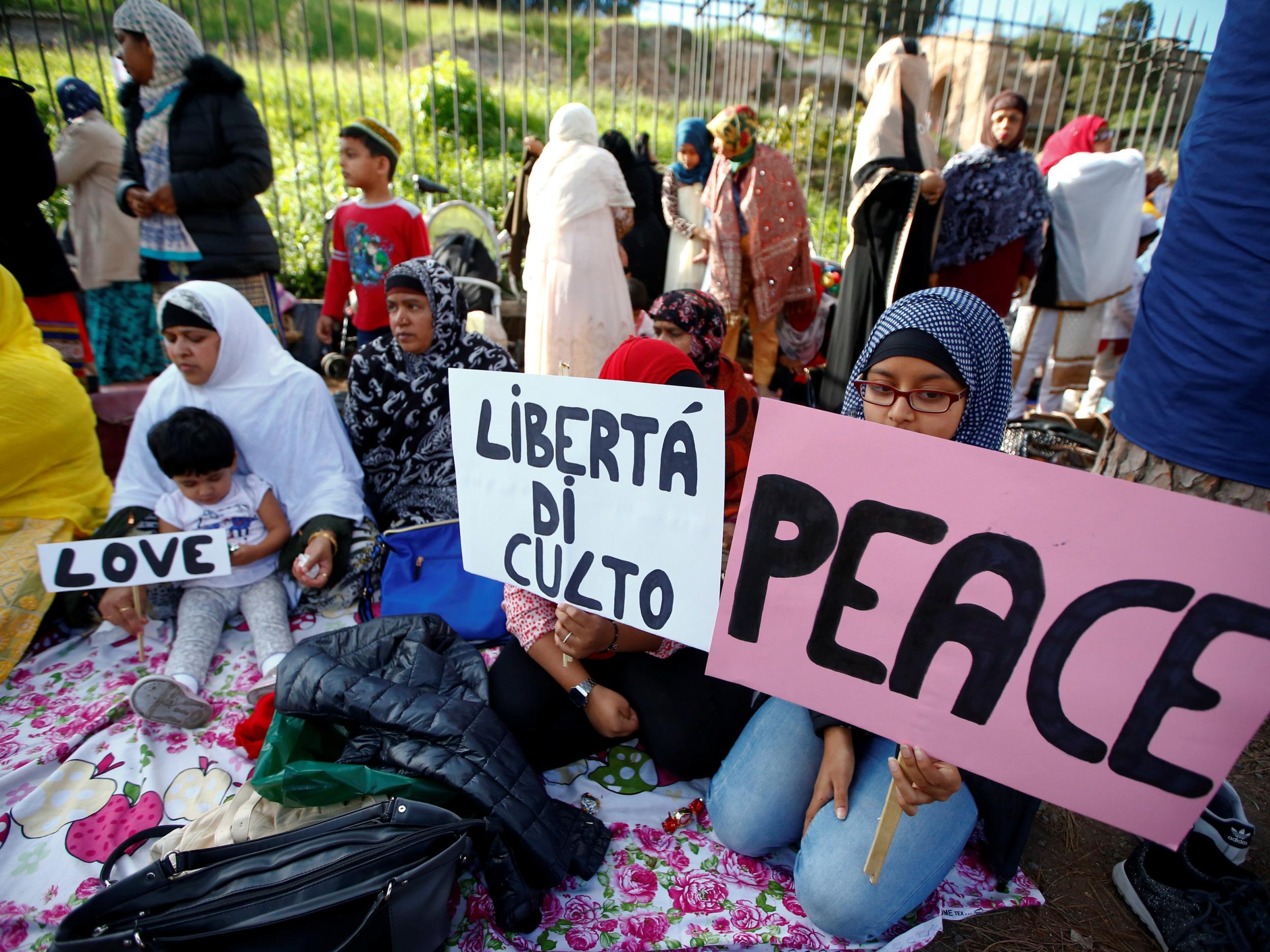 Muslims protest in Rome, holding signs reading 'Peace' and 'Open the mosques'