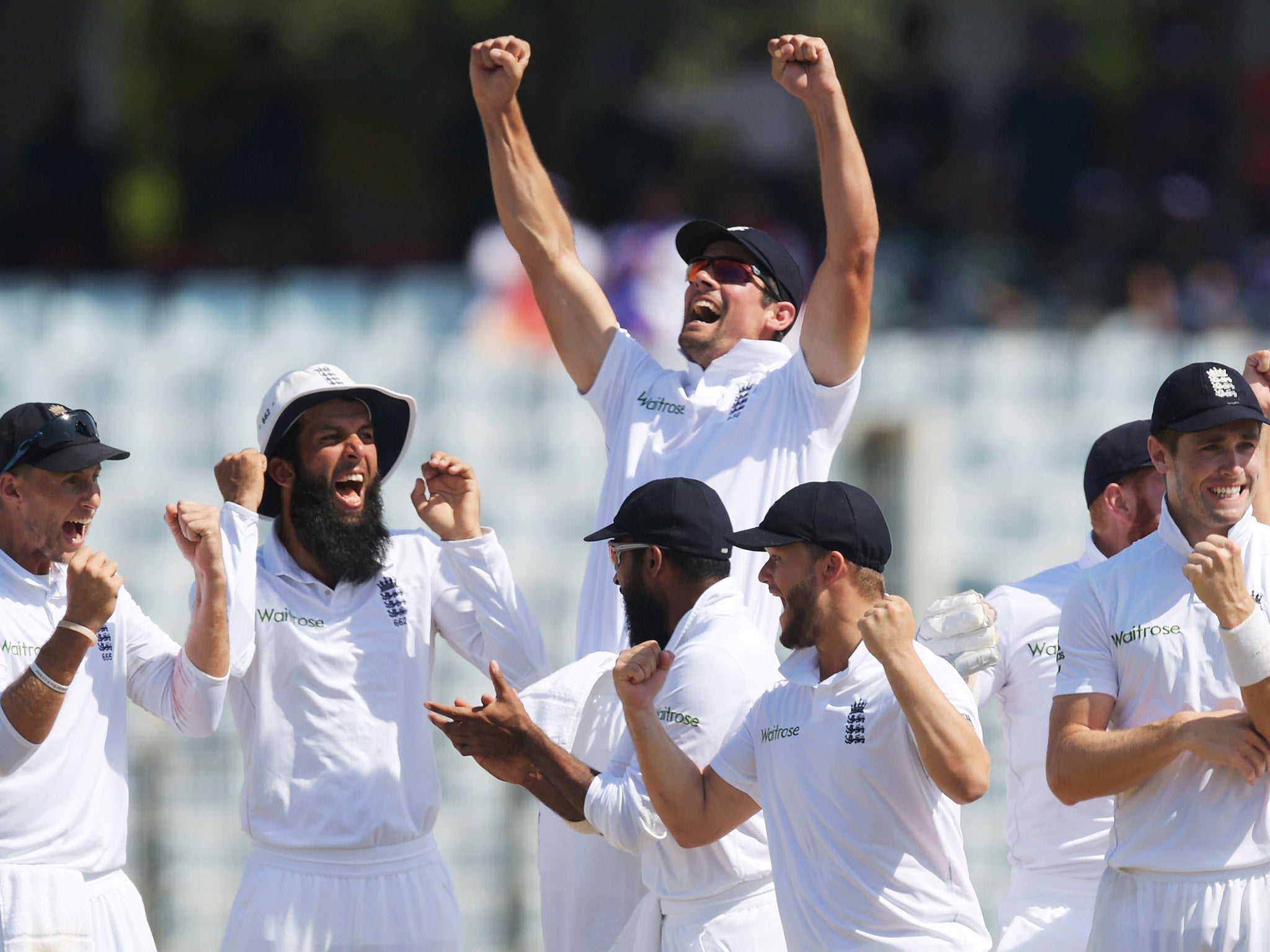 Alastair Cook celebrates with his England teammates after clinching a 22-run first Test victory over Bangladesh