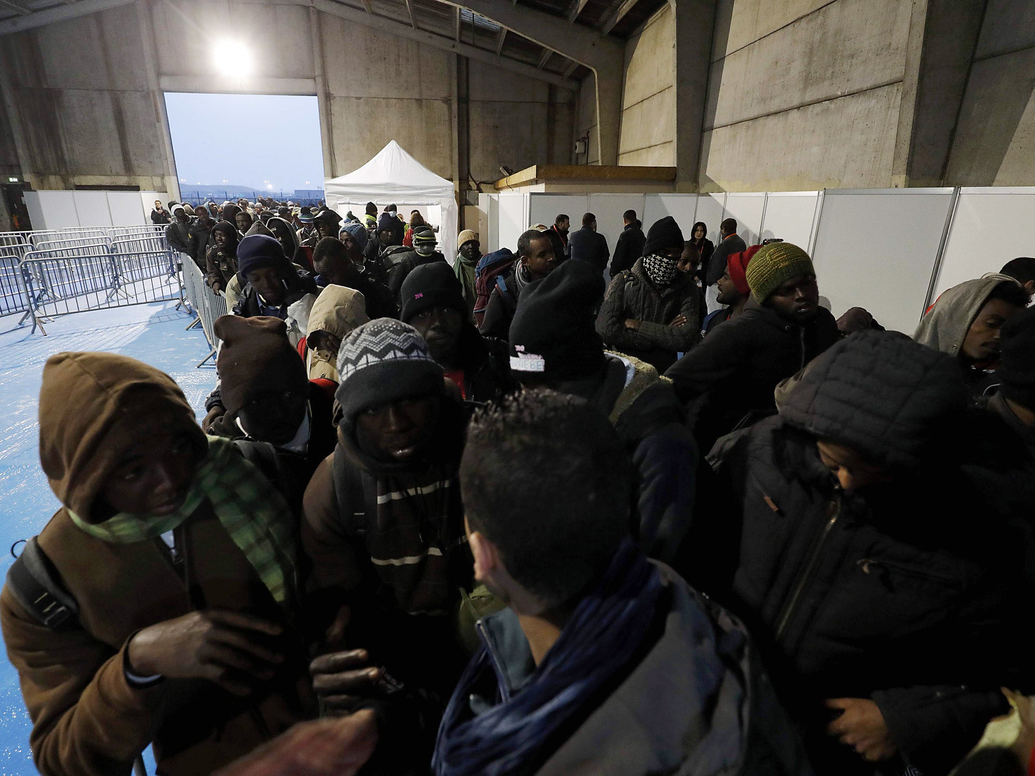 Migrants queue and transfer to reception centers in France