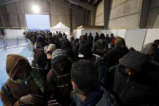 Migrants queue and transfer to reception centers in France