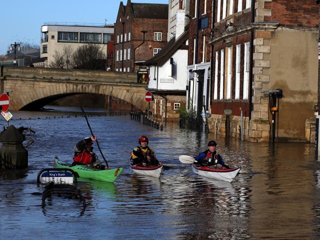 Canoeists check out buildings in flooded York on December 31, 2015
