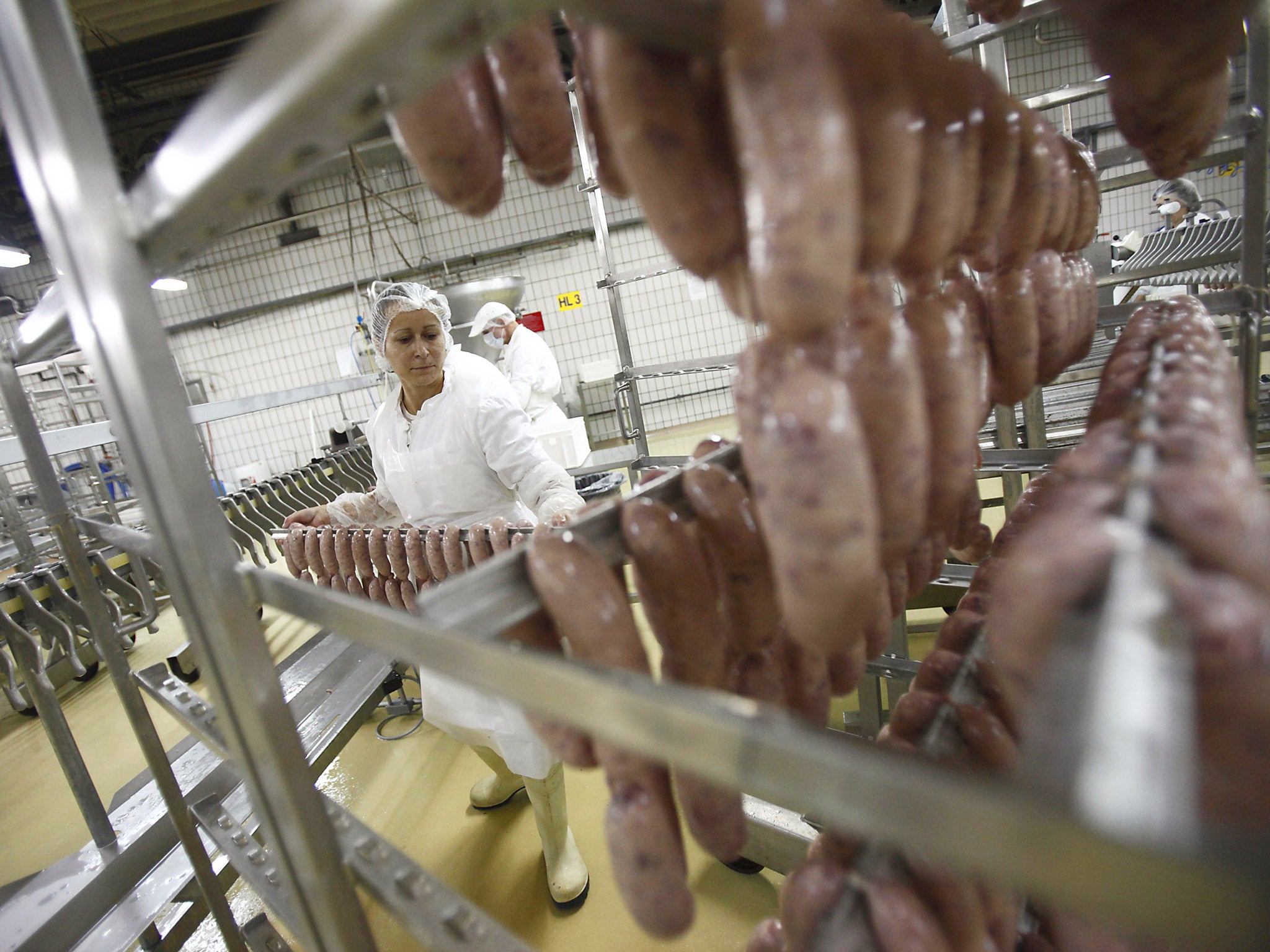 Workers produce Kranjska sausage at a factory in Petrinja, Croatia