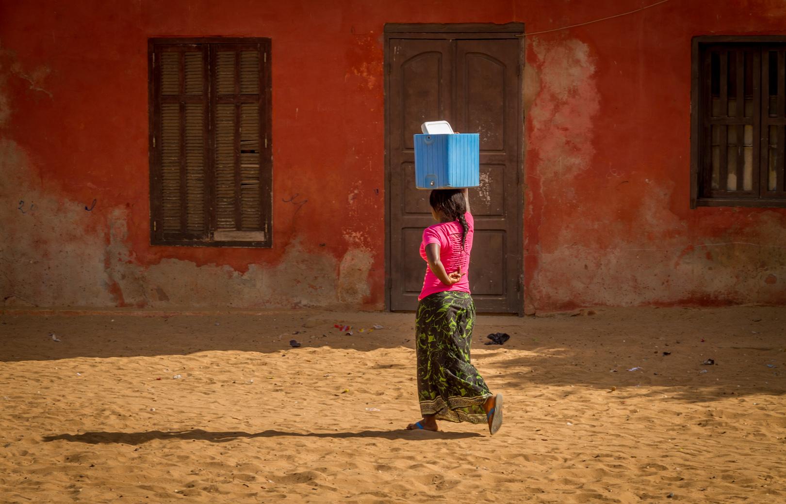 Women carry heavy loads on their heads