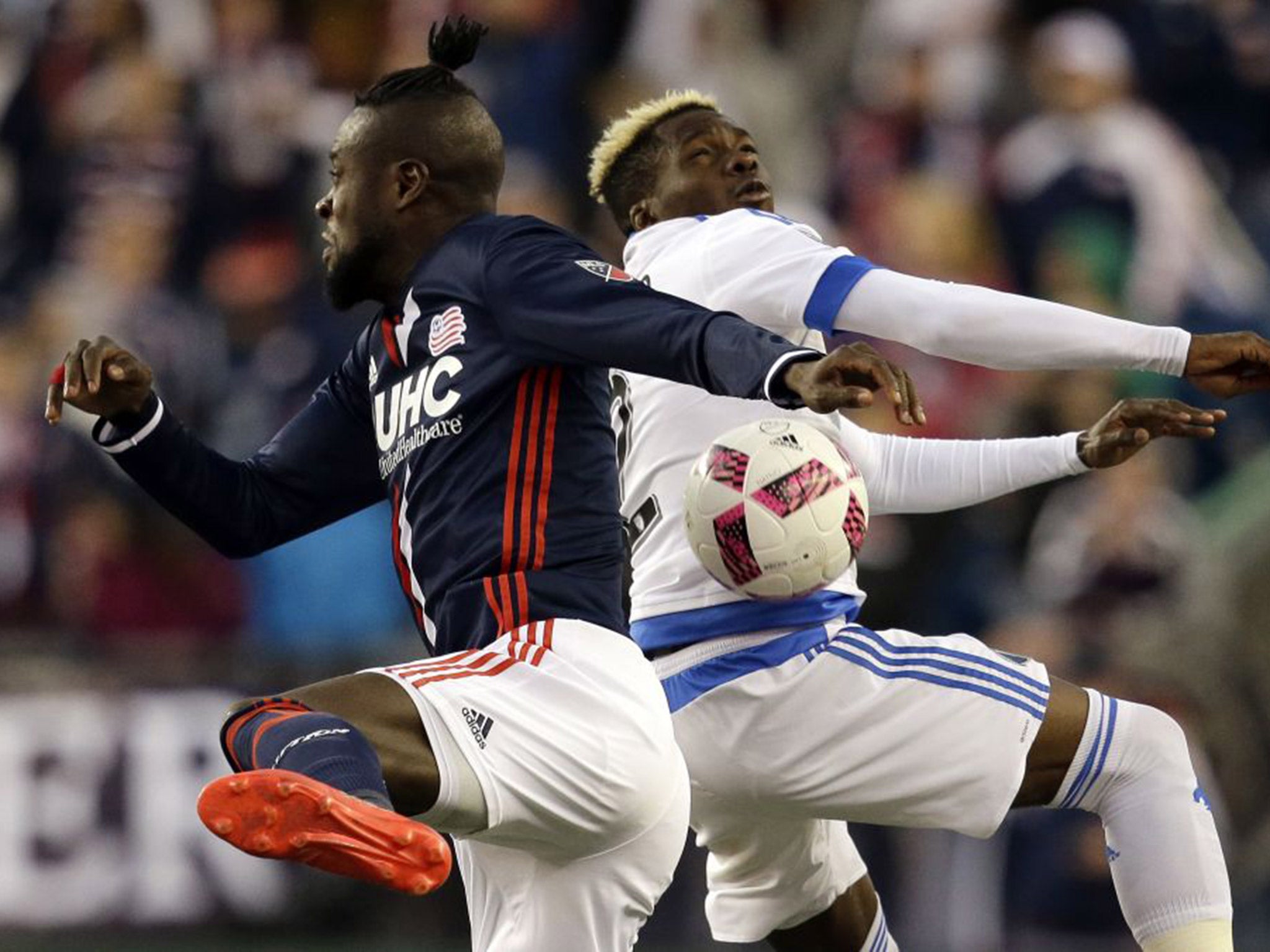 Kei Kamara (left) vies with Montreal's Ambroise Oyongo during New England's 3-0 win