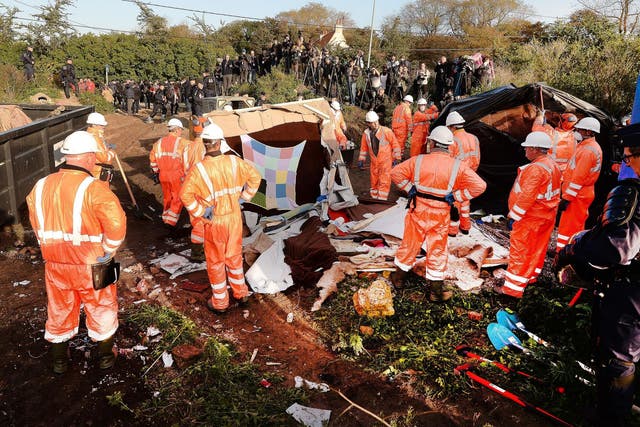 The demolition began as a team of workmen and riot police began dismantling empty tents