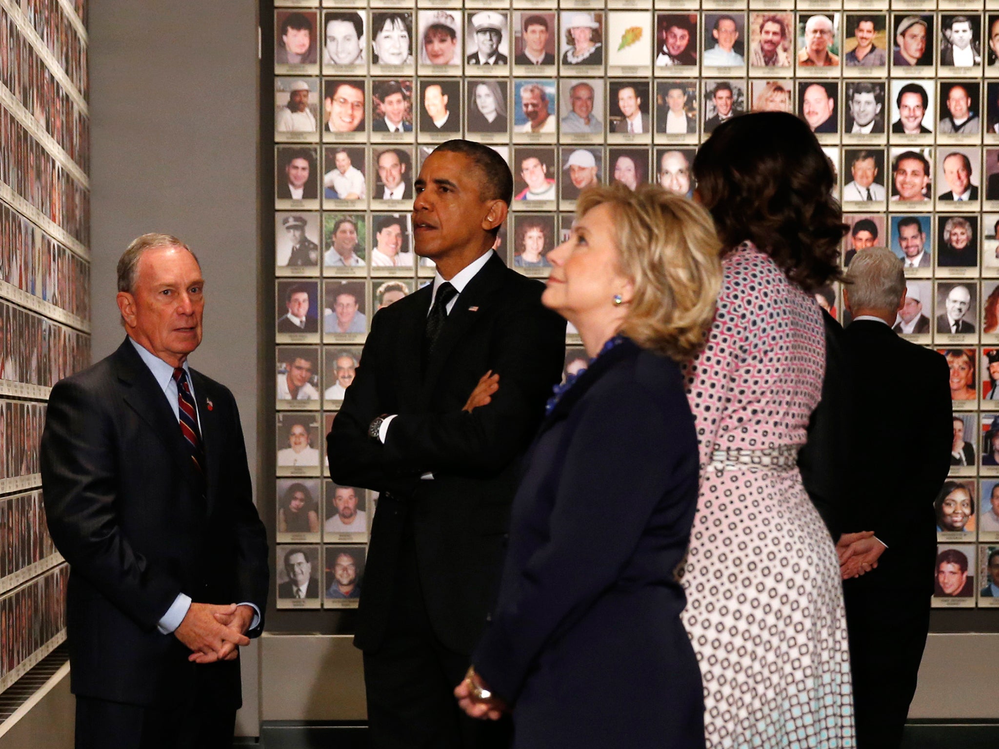 US President Barack Obama and former New York Mayor Michael Bloomberg look at the faces of those who died during the 9/11 attacks at the National September 11 Memorial Museum in New York