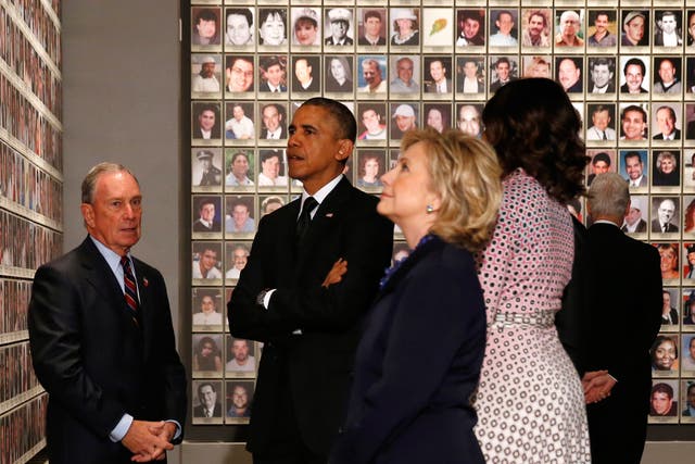 US President Barack Obama and former New York Mayor Michael Bloomberg look at the faces of those who died during the 9/11 attacks at the National September 11 Memorial Museum in New York