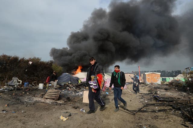Smoke rises over the Calais Jungle camp, as several large fires broke out in the near deserted migrant camp in northern France on the third day of the operation to clear it.