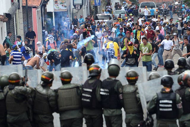 Demonstrators clash with members of Venezuelan National Guard during a rally in San Cristobal