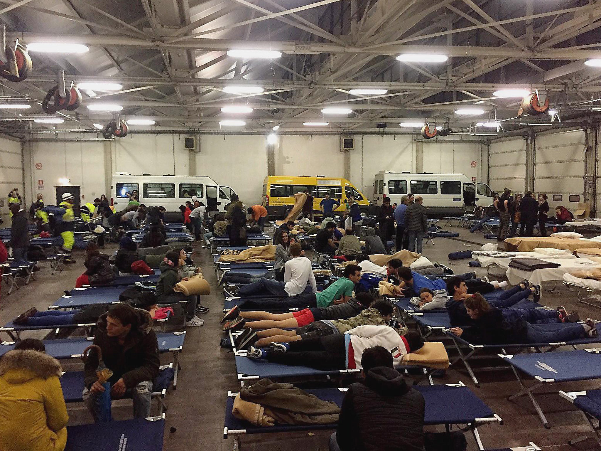 Evacuated people spend the night in a temporary shelter, in Camerino, Marche Region, central Italy