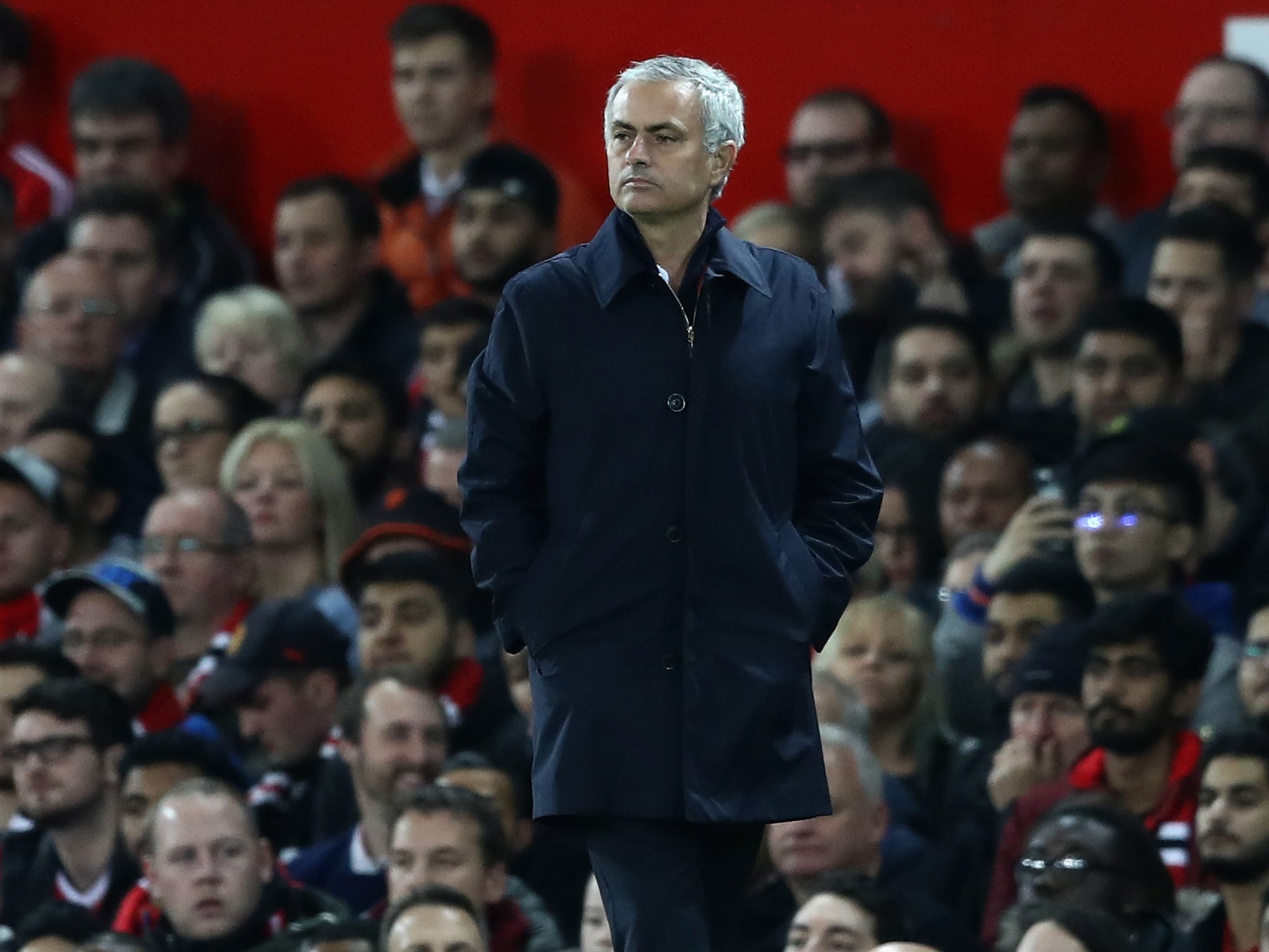 Mourinho stands on the Old Trafford touchline in front of United's support