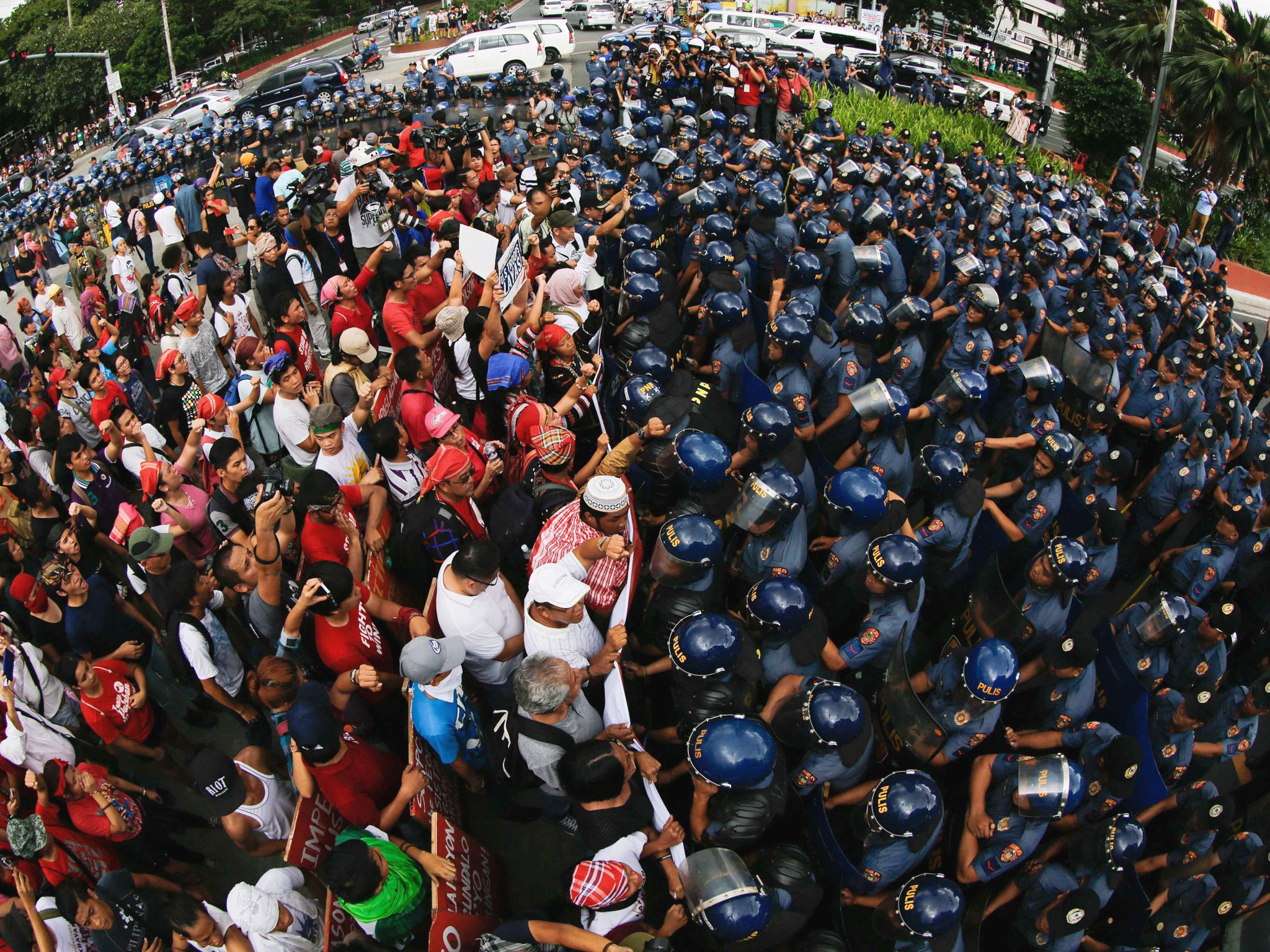 Filipino demonstrators face off with anti-riot police during a protest near the US Embassy in Manila, Philippine