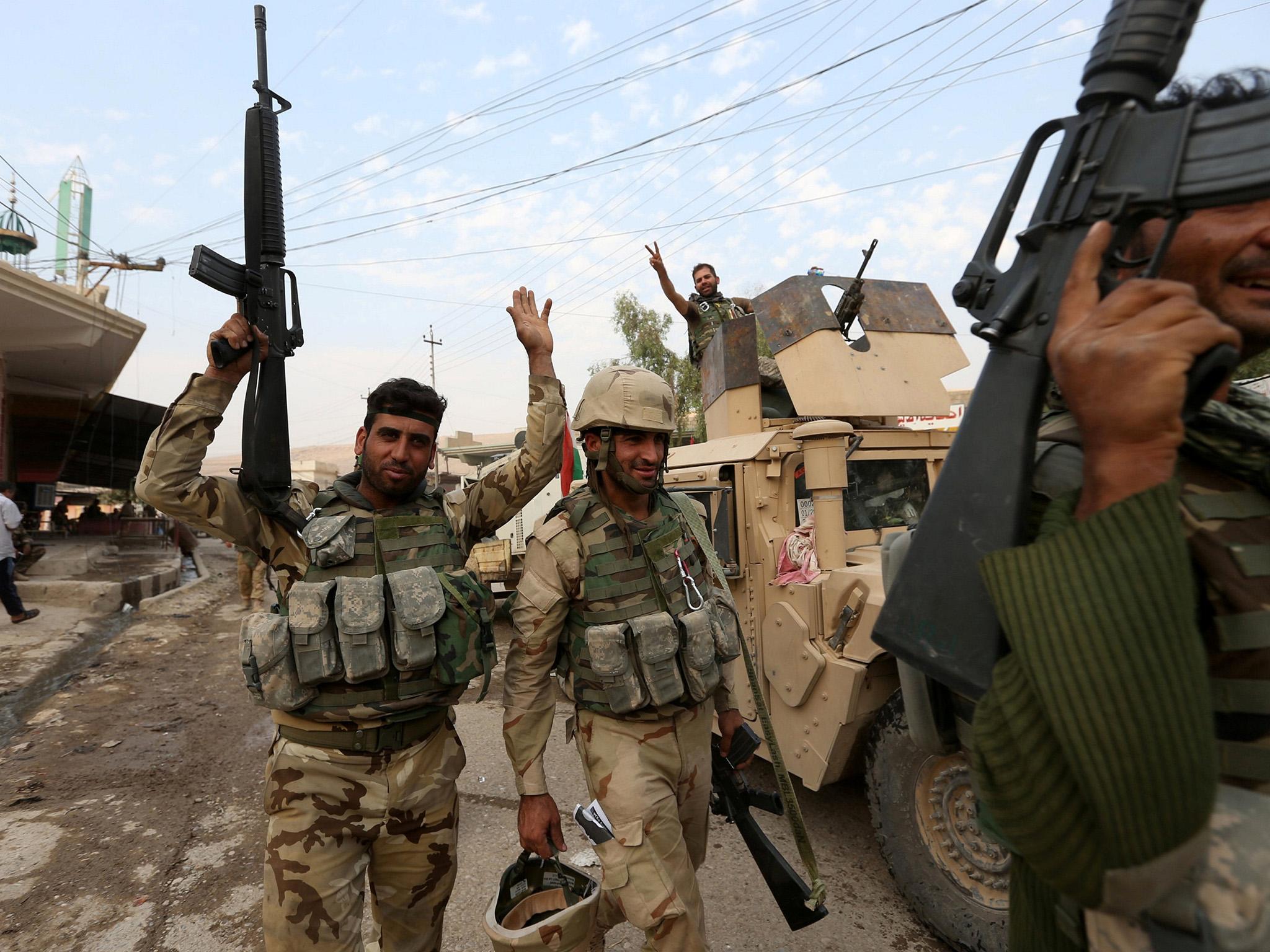 Kurdish Peshmerga fighters celebrate after recapturing Fadiliya village in Nawaran, north of Mosul
