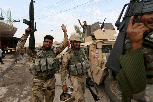 Kurdish Peshmerga fighters celebrate after recapturing Fadiliya village in Nawaran, north of Mosul