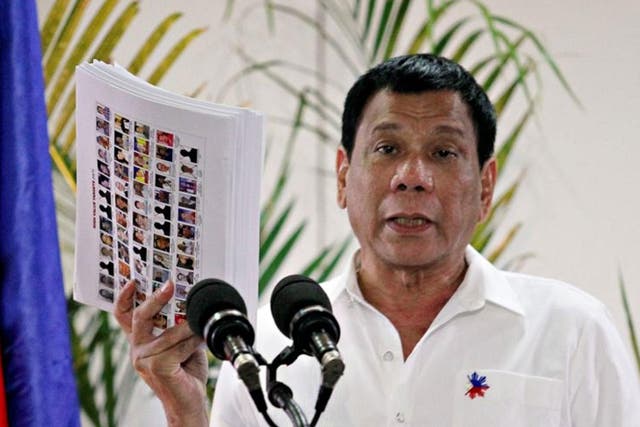 Philippine President Rodrigo Duterte shows the list of government, military and police officials involved in illegal drug trade during a news conference upon his arrival from a state visit in Japan at the Davao International Airport in Davao city, Philippines, 27 October, 2016