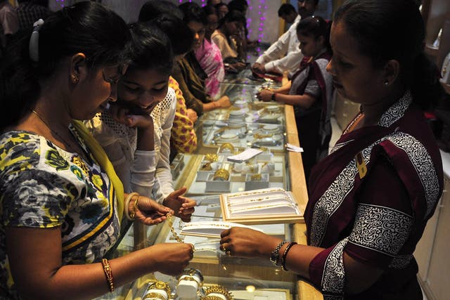 Indian shoppers browse gold jewellery for sale during Dhanteras, ahead of Diwali, in Agartala, the capital of India's northeastern state of Tripura