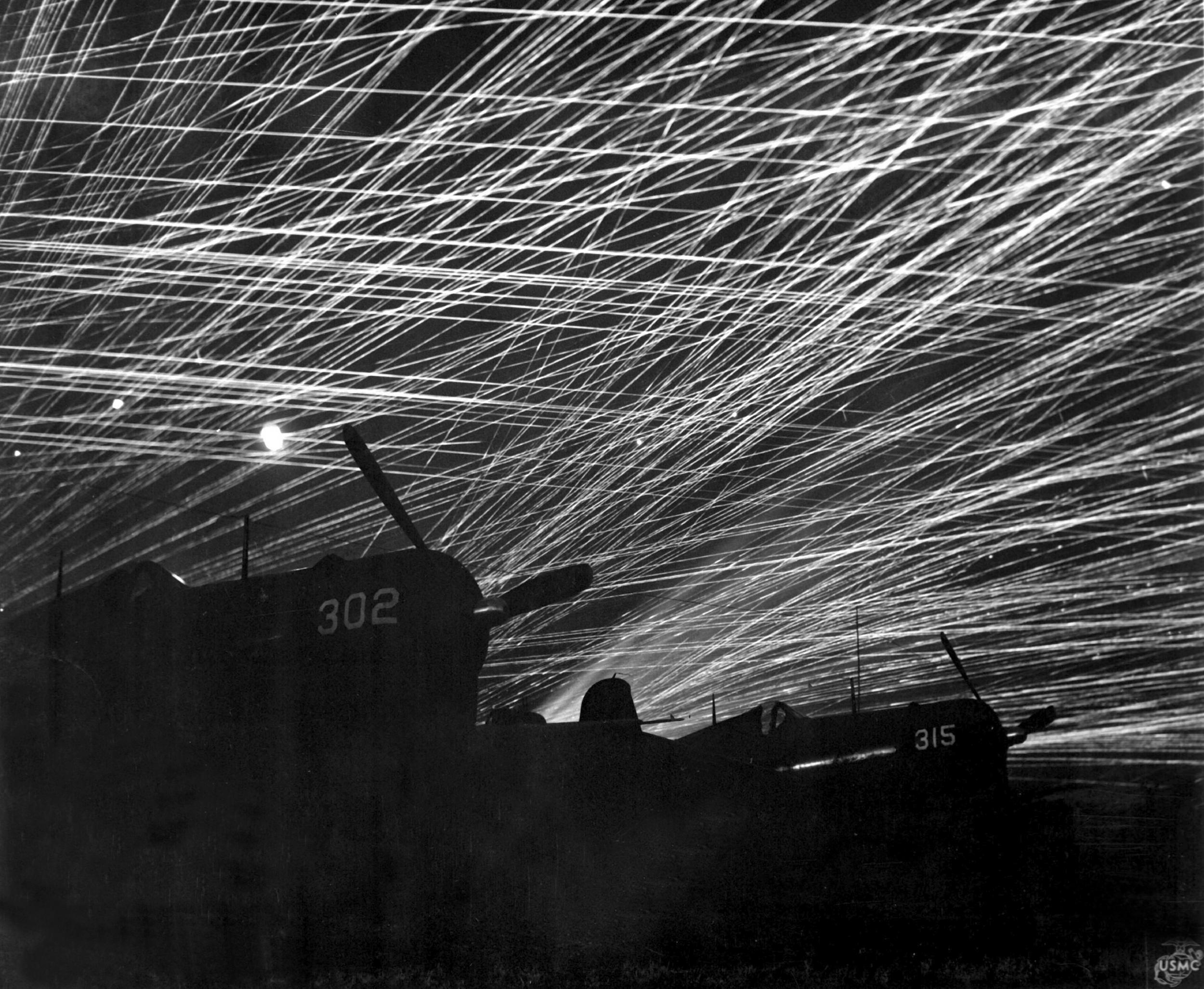 Japanese night raiders are greeted with a flak of anti-aircraft fire by the Marine defenders of Yontan airfield, on Okinawa, 1945