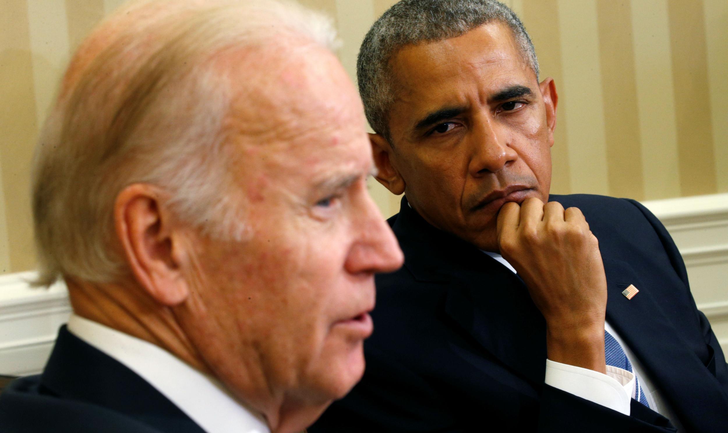 President Obama listens to Joe Biden speak of his work on defeating cancer on 18 October in the White House