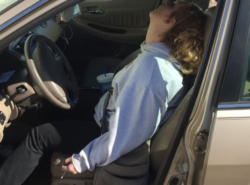 Erika Hurt pictured with a syringe still in her hand after overdosing with her son in the backseat