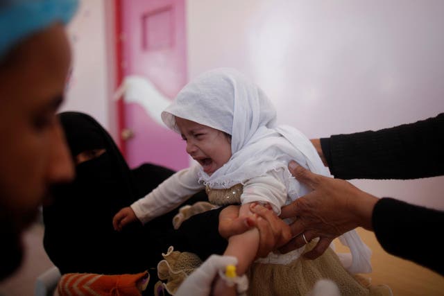 A girl cries as she is treated at a cholera treatment centre in Sanaa
