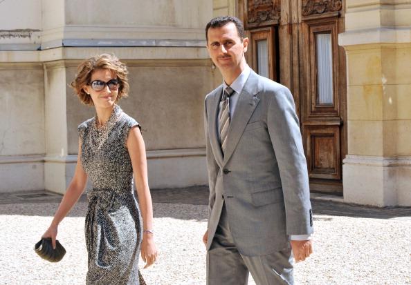 Syrian President Bashar al-Assad (R) and his wife Asma (L) in Paris in a file photograph from 2008