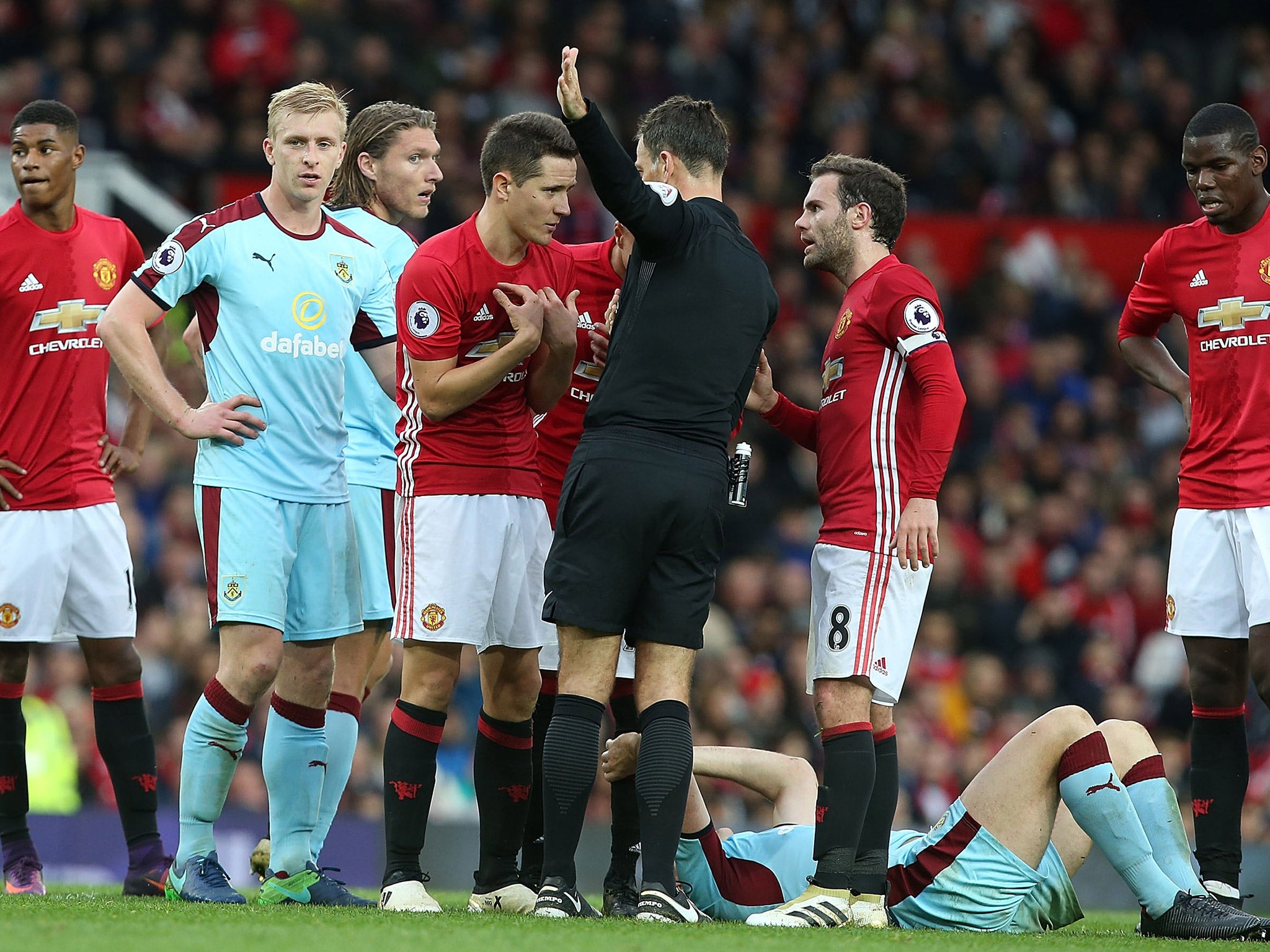 Ander Herrera is shown a red card by referee Mark Clattenburg