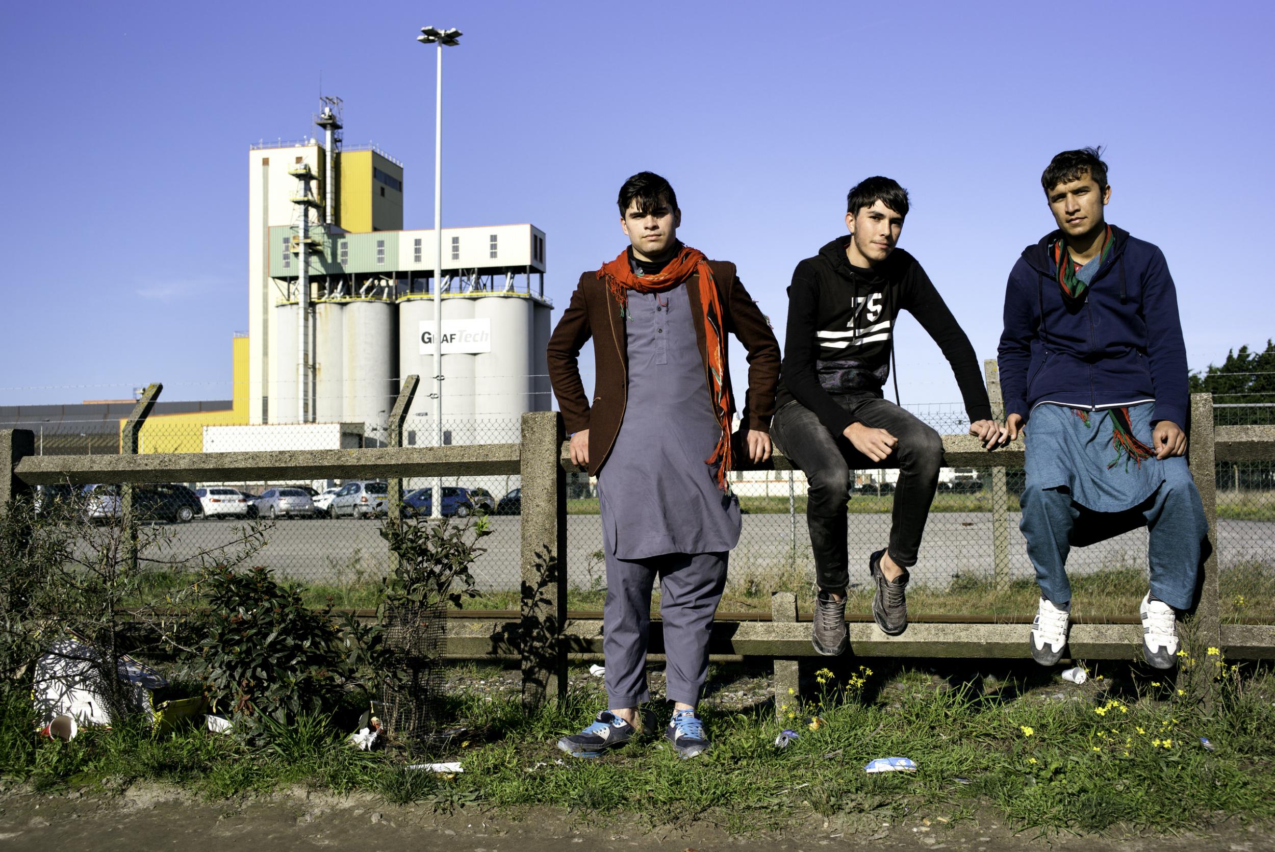 Three young men waiting to find out where they are heading (Photo: Emily Garthwaite)