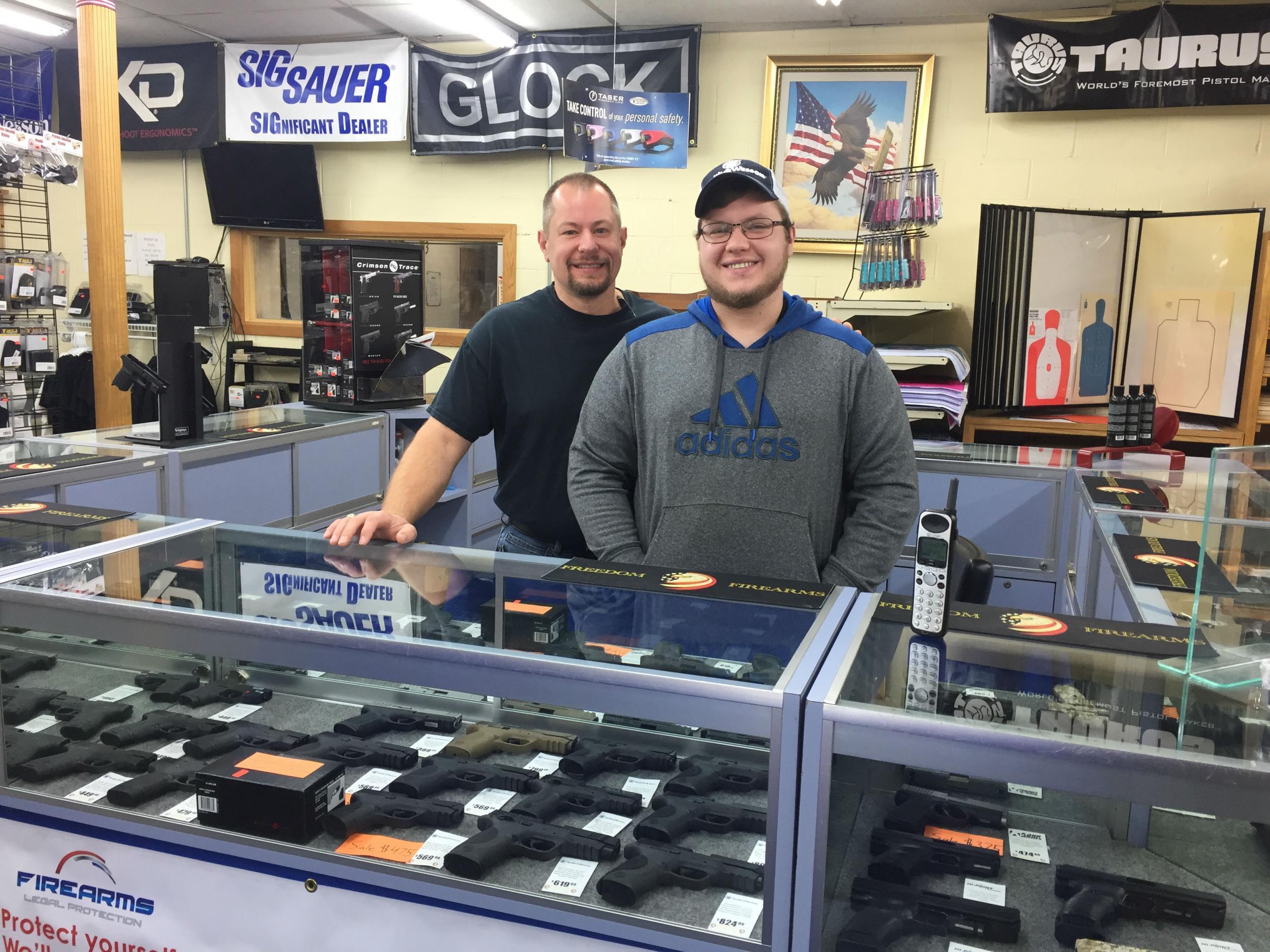 Joel Fulton and his son, Dave, minding one of the counters at Freedom Firearms