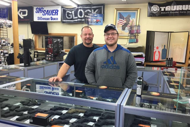 Joel Fulton and his son, Dave, minding one of the counters at Freedom Firearms