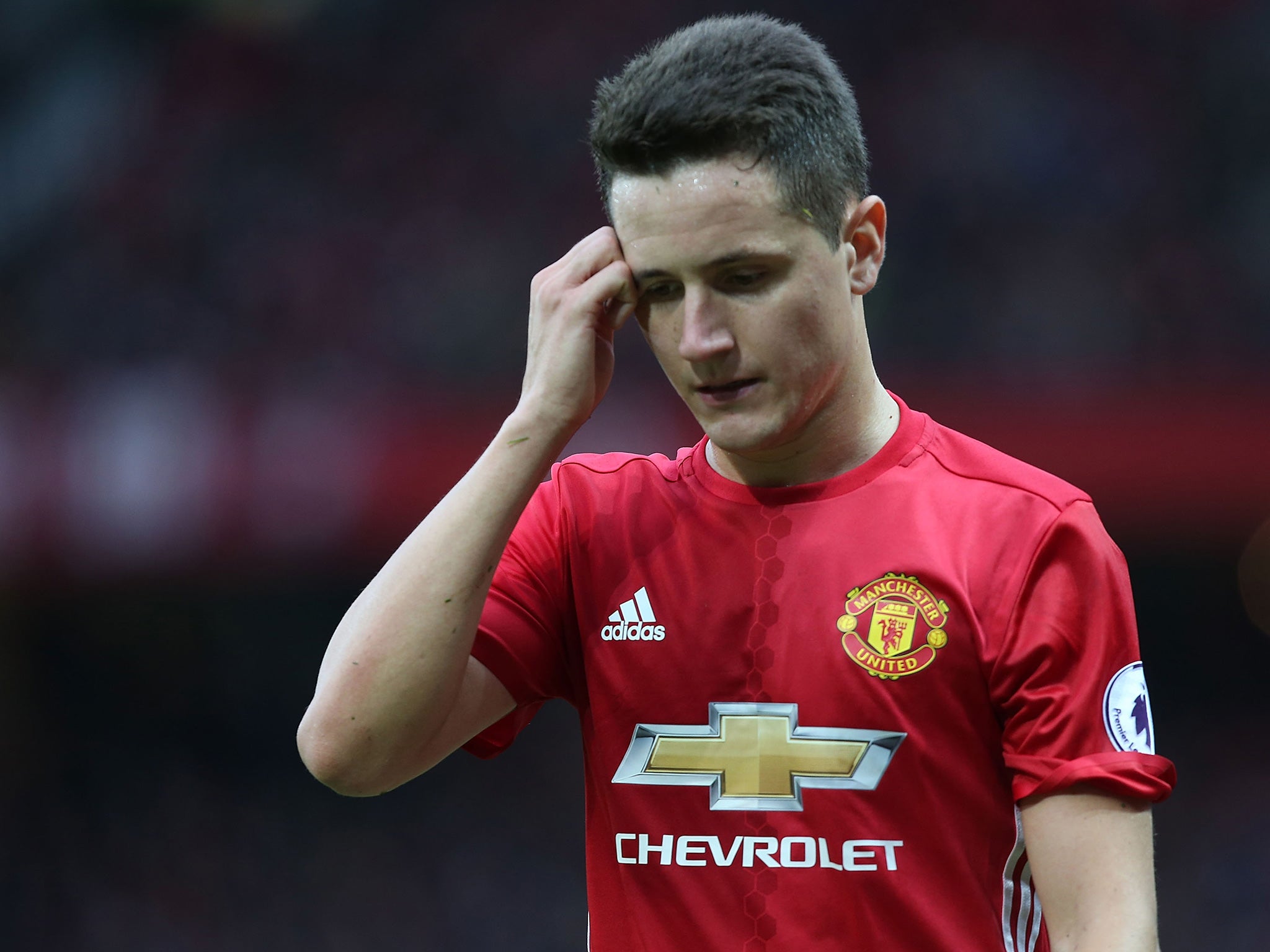 Herrera walks off the Old Trafford pitch after receiving a second yellow card