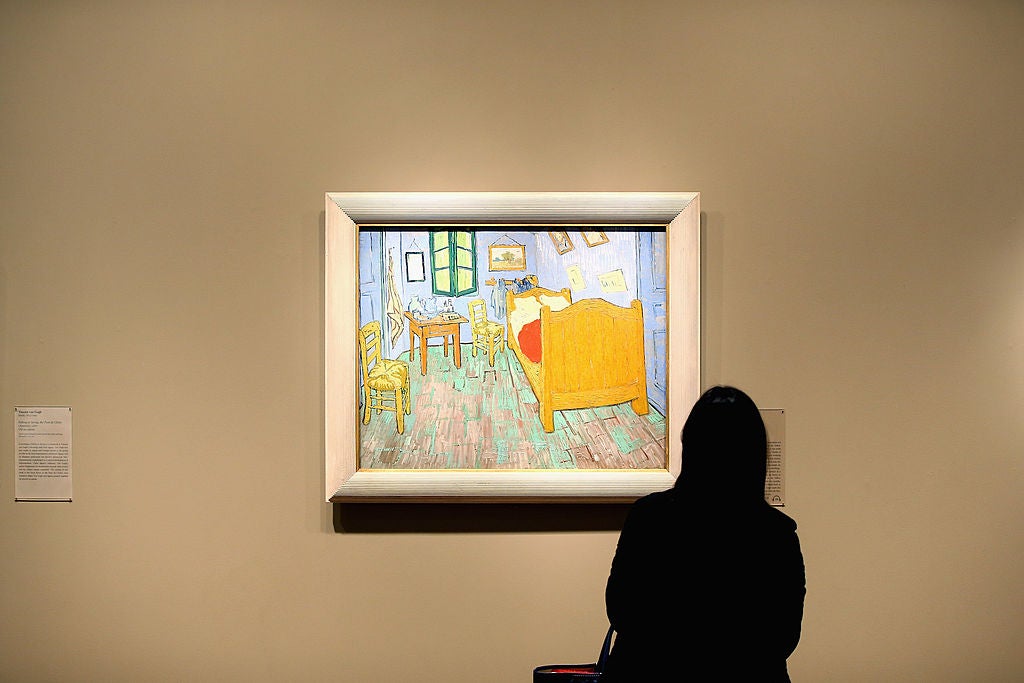 A visitor looks over Vincent van Gogh's The Bedroom at the Art Institute of Chicago