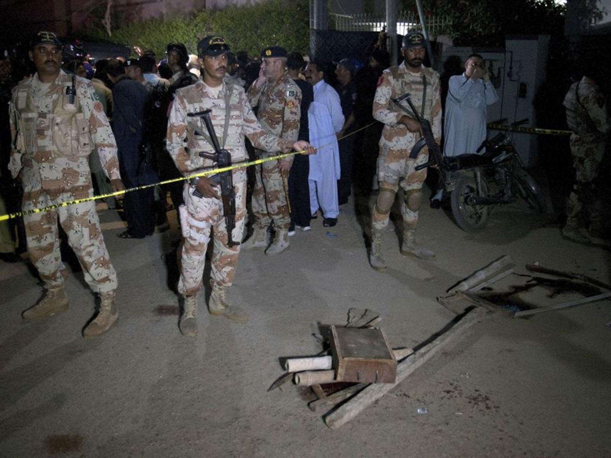 Paramilitary soldiers gather at the site attack in Karachi, Pakistan, Saturday, 29 October, 2016