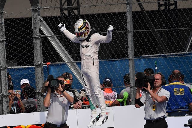 Lewis Hamilton celebrates winning the Mexico Grand Prix