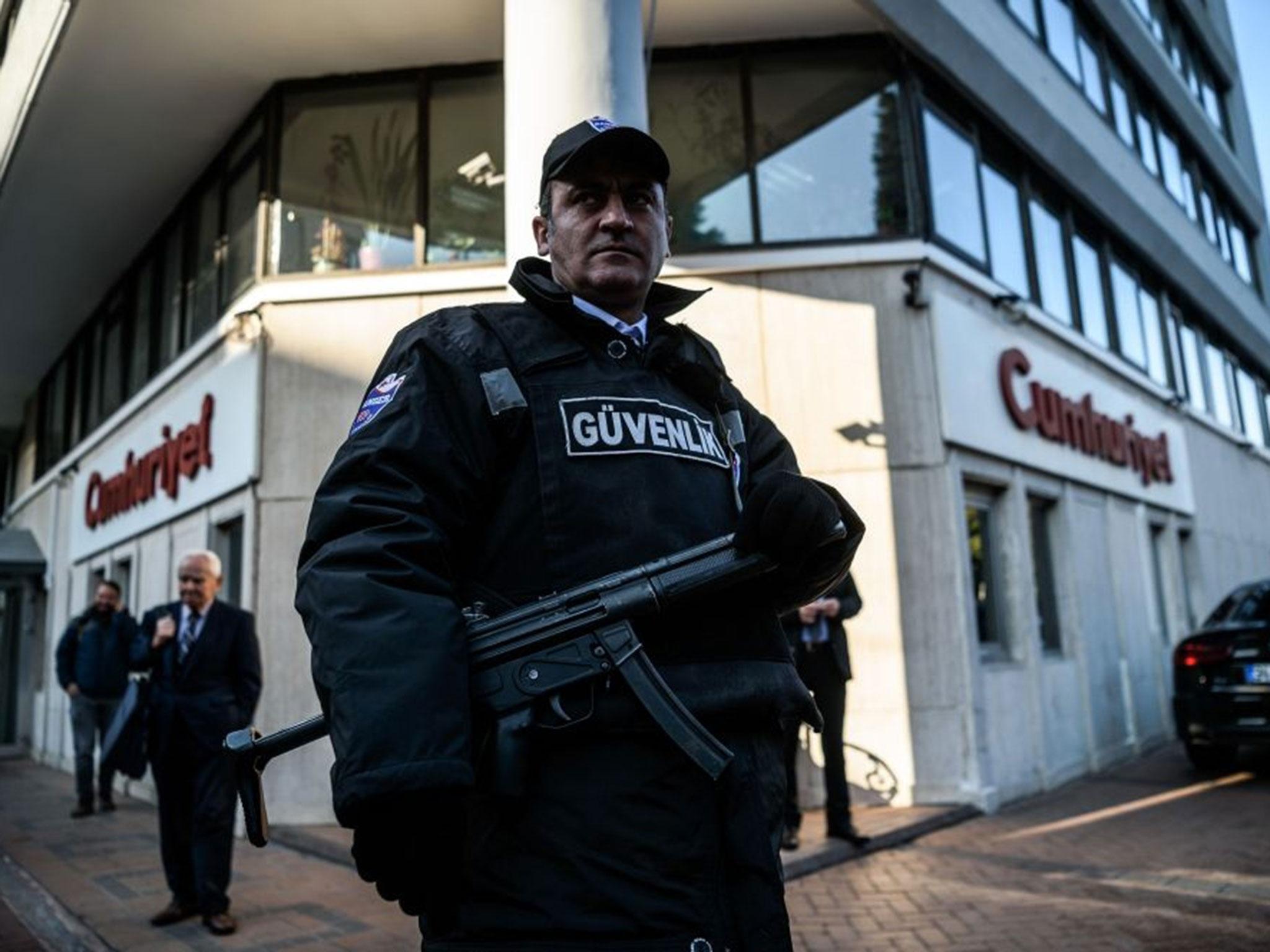 A security agent stands guard in front of Cumhuriyet newspaper headquarters in Istanbul on 31 October, 2016