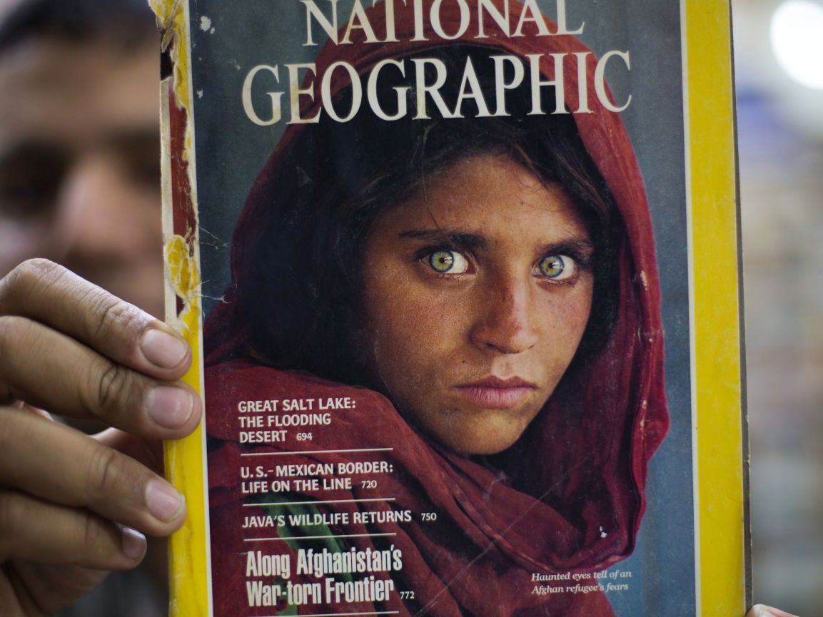 A copy of a National Geographic magazine with the photograph of Afghan refugee woman Sharbat Gulla