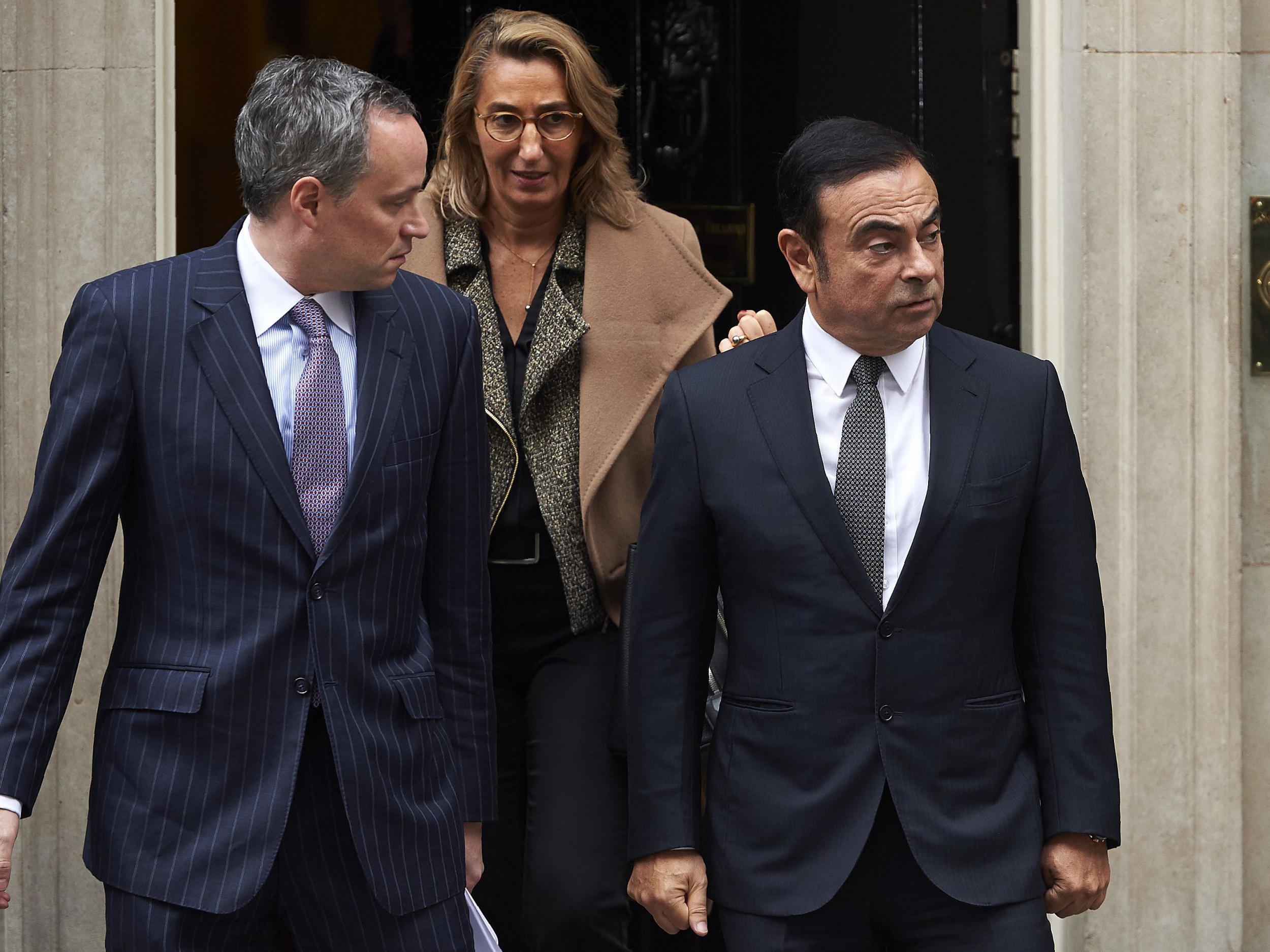 Nissan CEO Carlos Ghosn (R) leaves No 10 Downing Street after meeting with British Prime Minister Theresa May