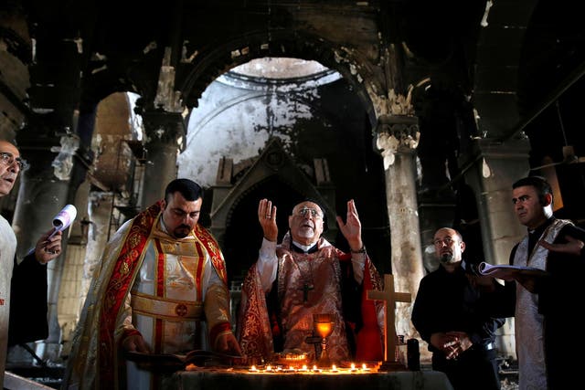 Iraqi priests hold Sunday mass at a church in Qaraqosh last month, after the town was recaptured from Isis