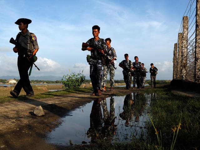 Myanmar police officers patrol along the border fence between Myanmar and Bangladesh in Maungdaw, Rakhine State, Myanmar, Friday, 14 October, 2016