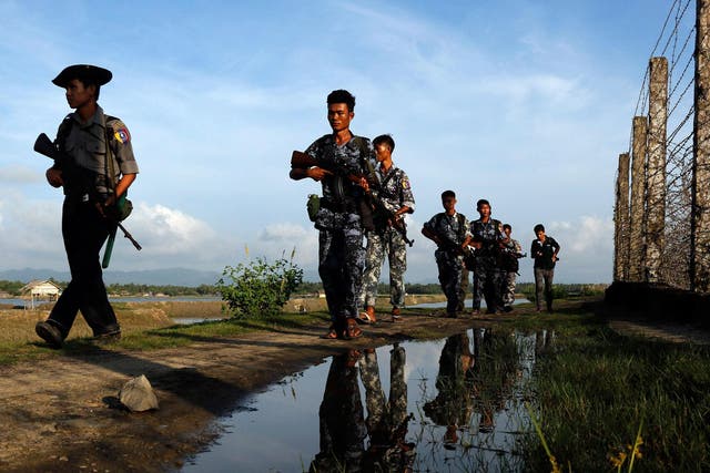 Myanmar police officers patrol along the border fence between Myanmar and Bangladesh in Maungdaw, Rakhine State, Myanmar, Friday, 14 October, 2016