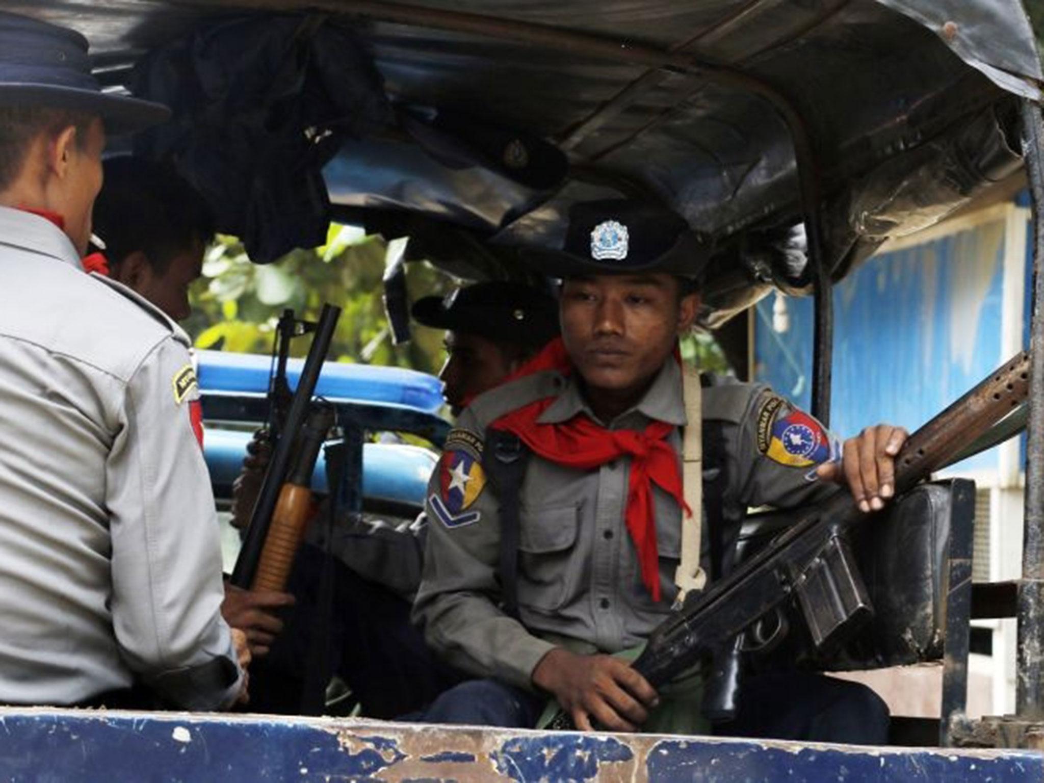 &#13;
Burmese police officers sit in a truck as they provide security in Maungdaw, Rakhine State, Burma, a border town with Bangladesh on Thursday, 13 October, 2016. Just five months after her party took power, Burma's Nobel Peace Prize-winning leader, Aung San Suu Kyi, is facing international pressure over recent reports that soldiers have been killing, raping and burning homes of the country's long-persecuted Rohingya Muslims &#13;