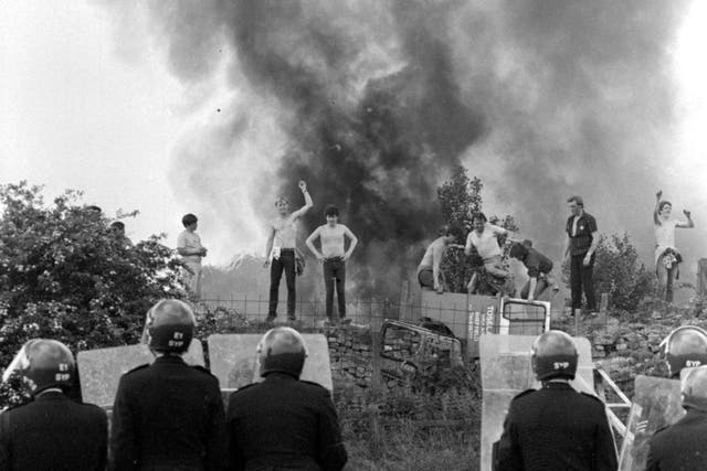 Miners strike - Riot police look on at picketers and burning cars at the Orgreave coking works in Yorkshire in June, 1984