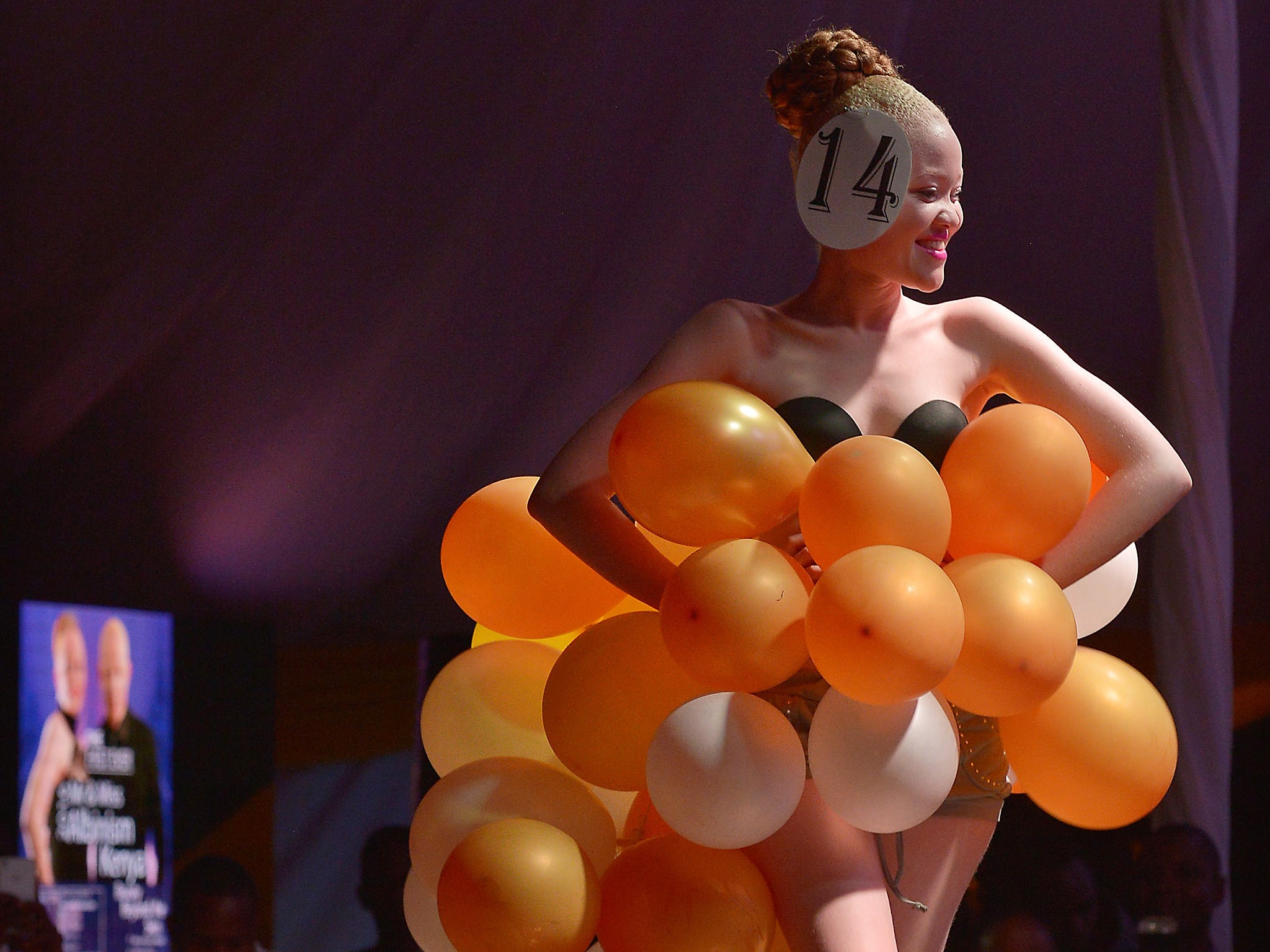 A contestant walks down the catwalk in her own creation at a pageant hosted by the Albinism Society of Kenya in Nairobi