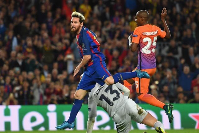 Lionel Messi scores against Manchester City in their clash with Barcelona at the Nou Camp