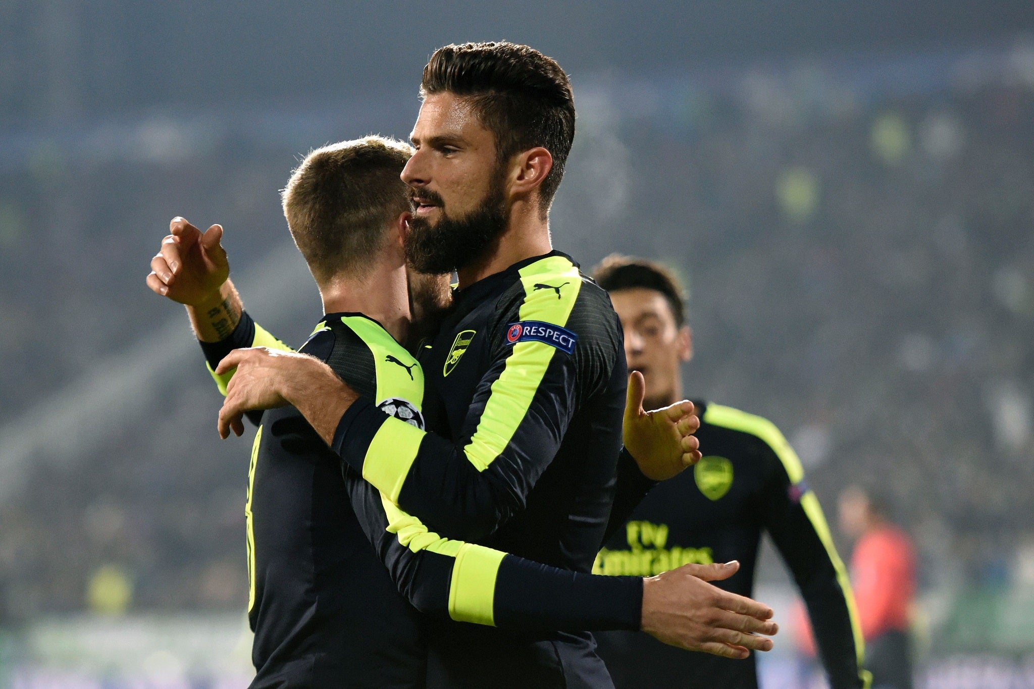 Olivier Giroud celebrates with Aaron Ramsey after heading in his cross to level the scores at 2-2