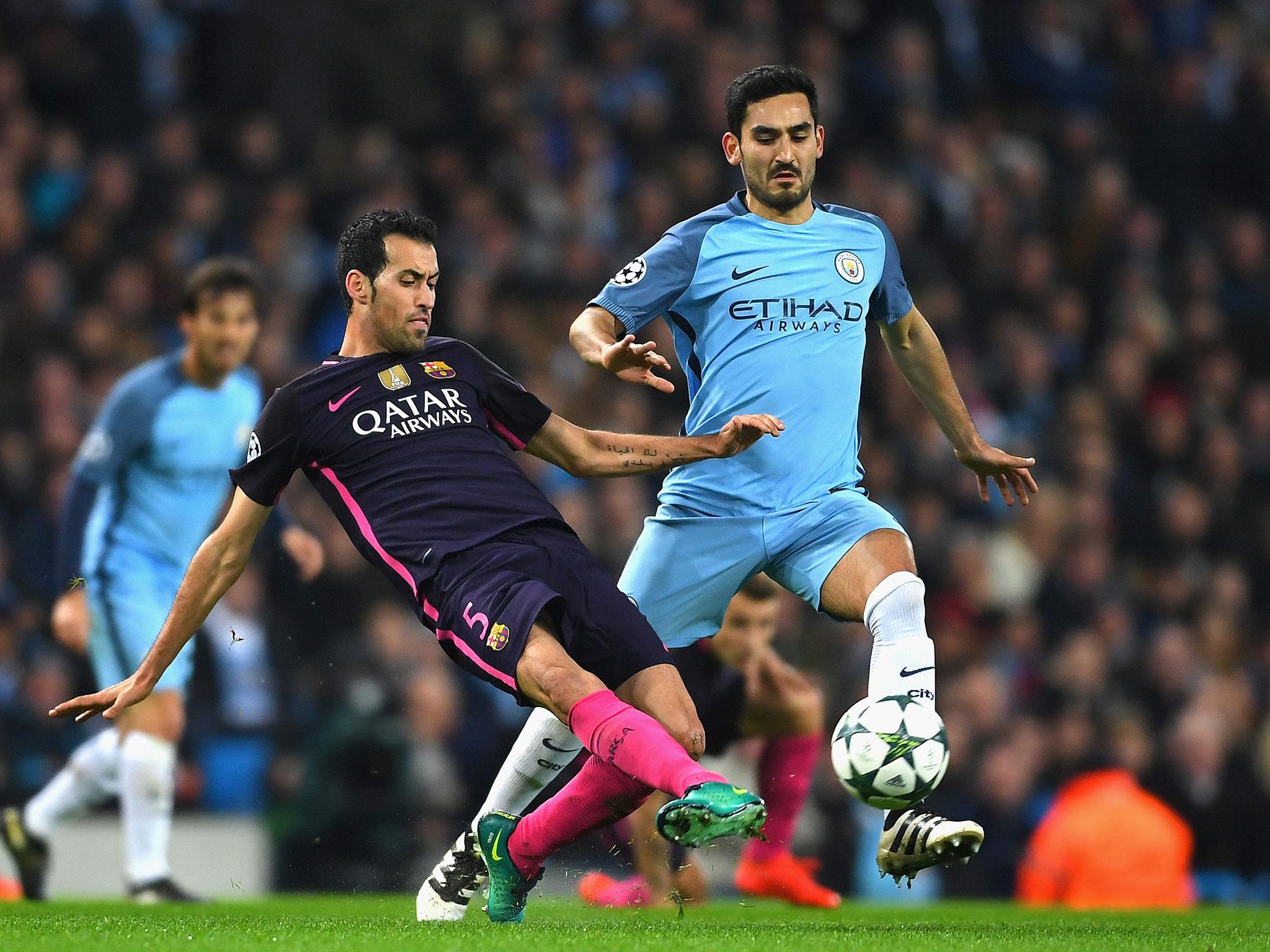 Sergio Busquets attempts to disposses Gundogan with a sliding challenge (Getty)