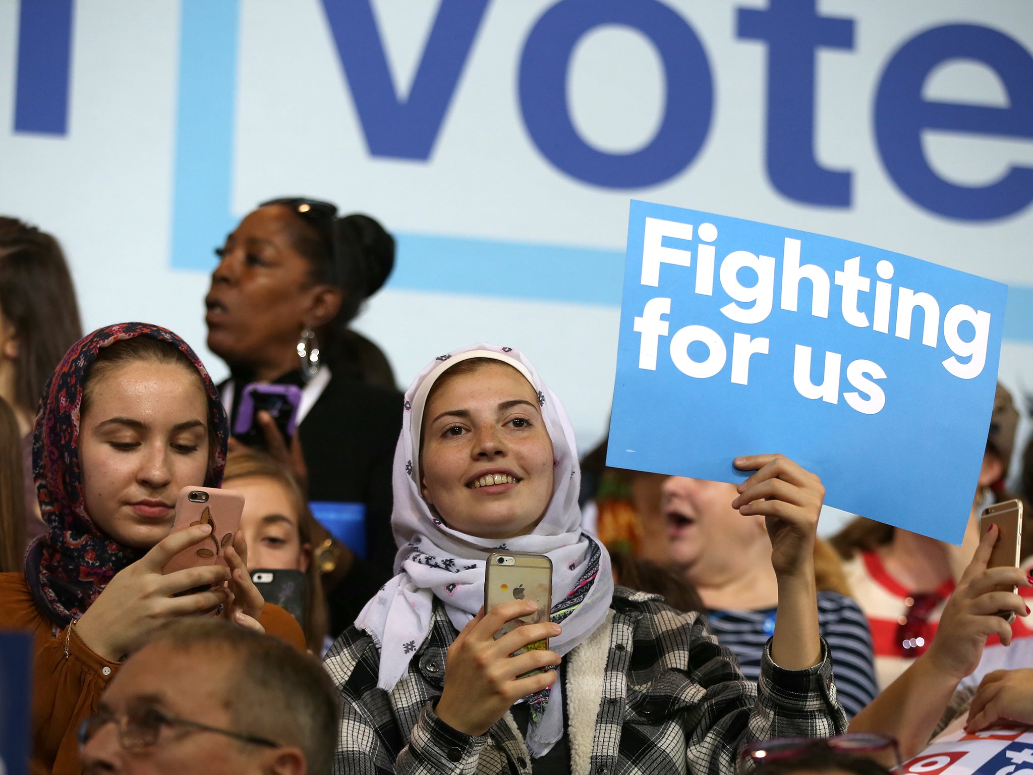 American-Muslim women listen to Democratic presidential nominee Hillary Clinton speak at a voter registration rally at Wayne State University in Detroit, Michigan