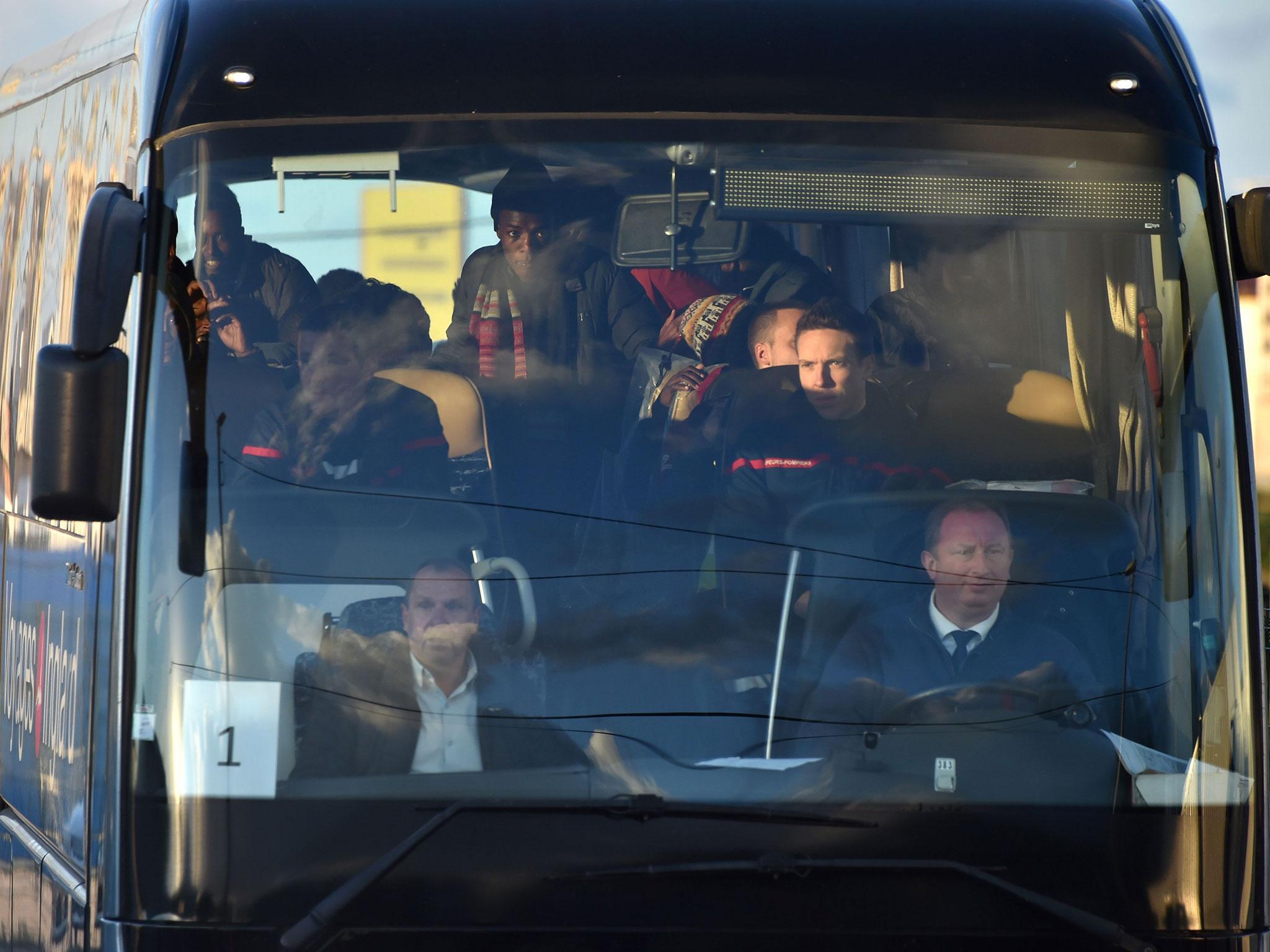 Unaccompanied minors living near the demolished Jungle camp in Calais, housed in specially outfitted shipping containers, are pictured in a bus leaving for a reception centre