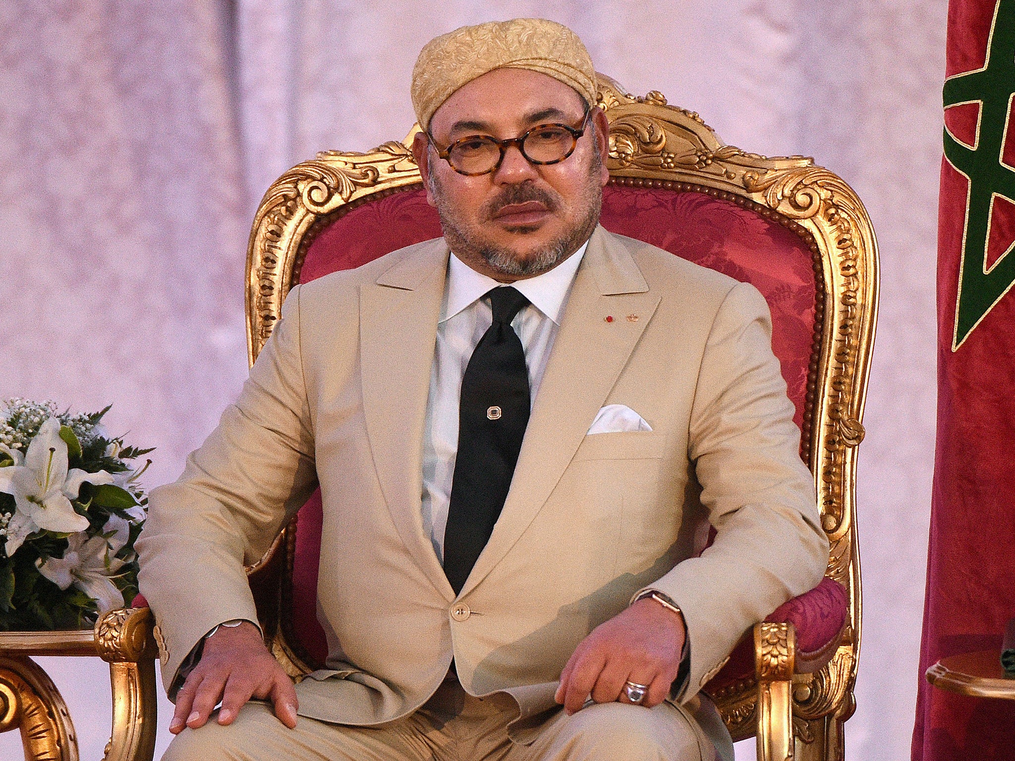 Morocco's King Mohammed VI looks on during the signing of an agreement with the French President in preparation of the COP21 climate talks in Paris
