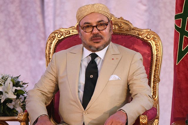 Morocco's King Mohammed VI looks on during the signing of an agreement with the French President in preparation of the COP21 climate talks in Paris